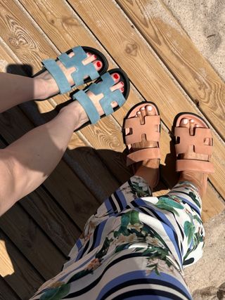 Two women wearing Hermès sandals.