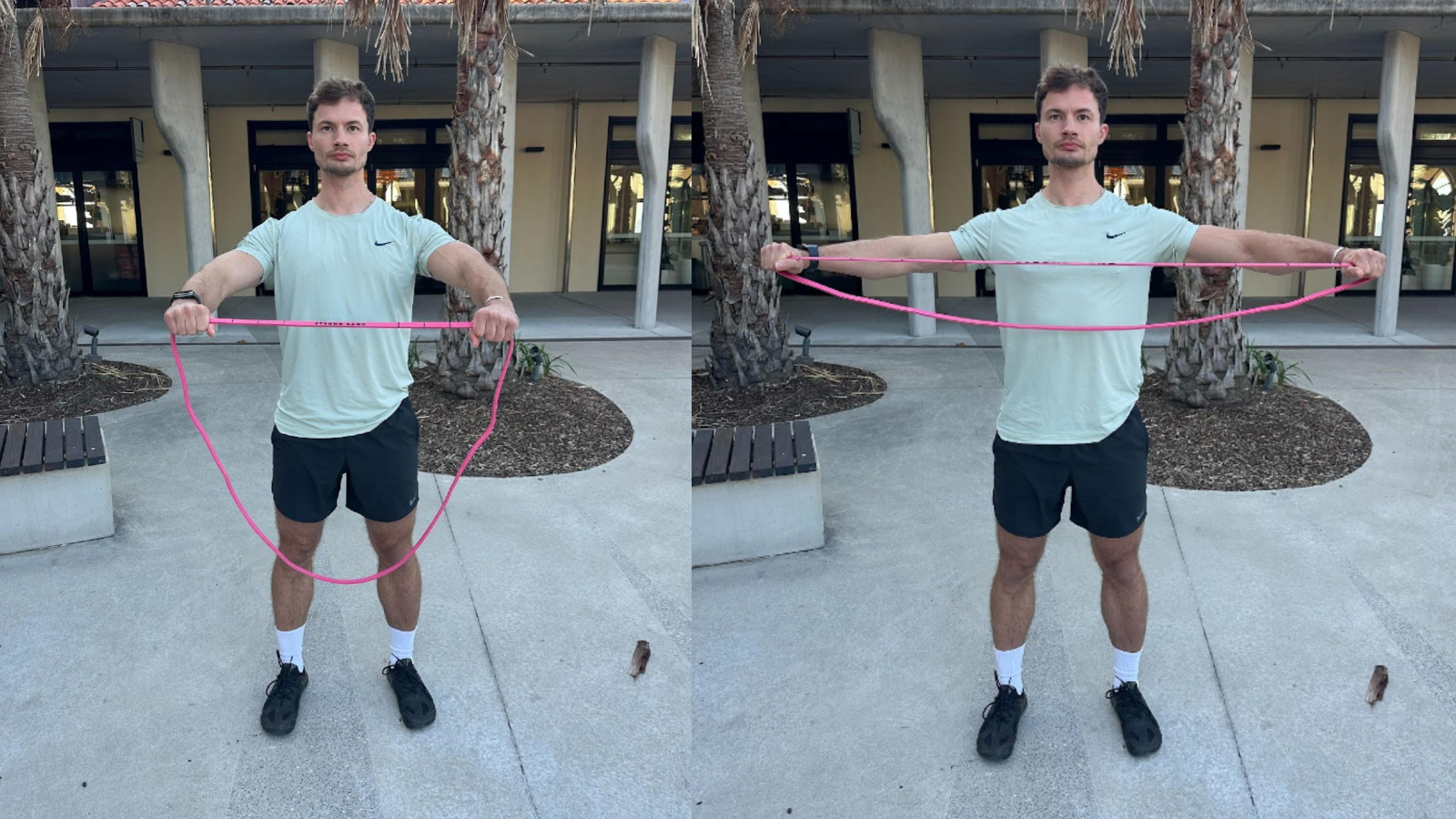 Man performing band pull apart with resistance band