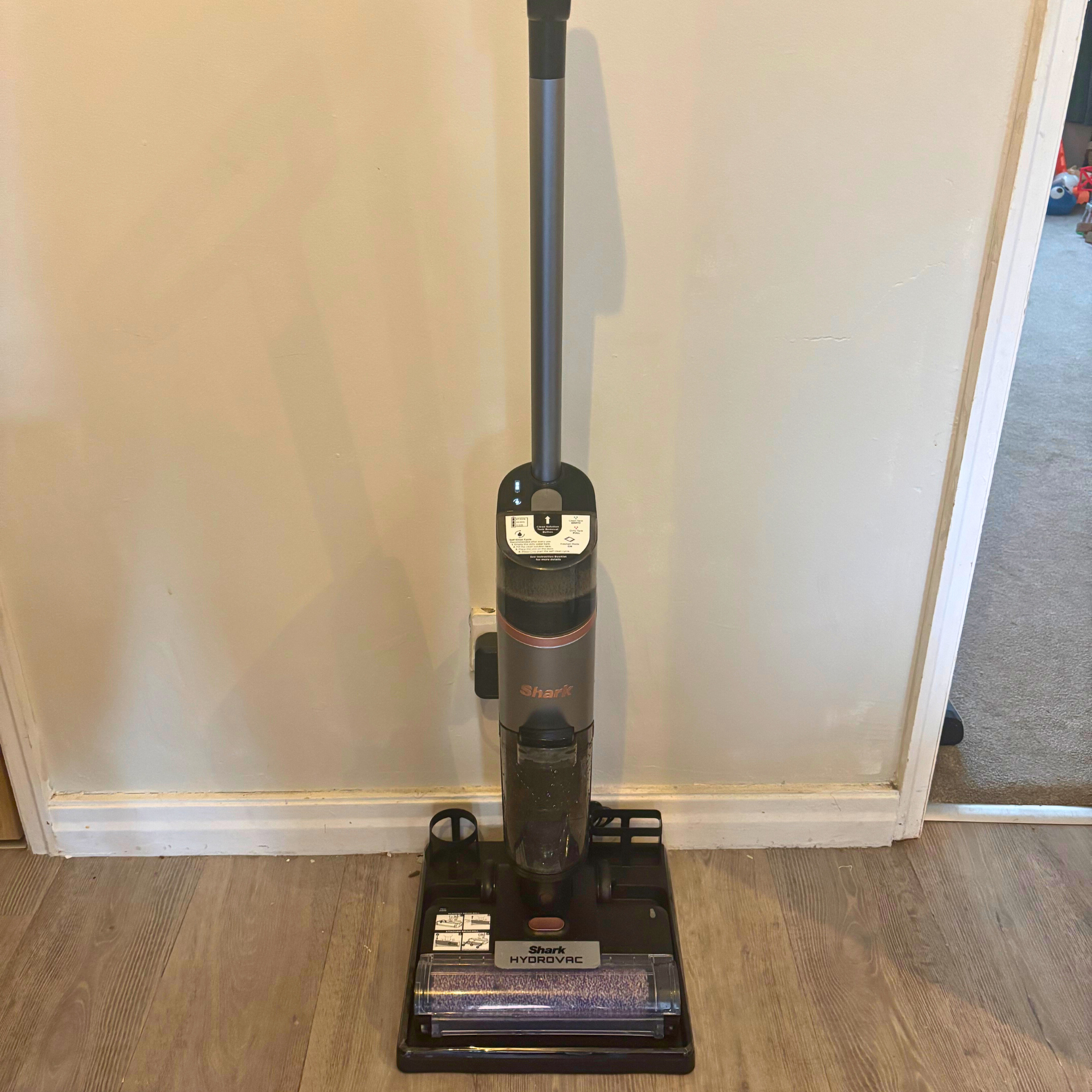 Front view of Shark HydroVac Cordless Hard Floor Cleaner positioned on docking station