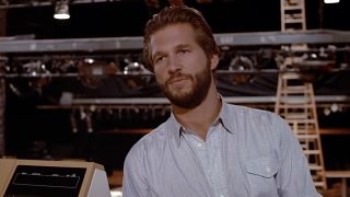 Jeff Bridges with a beard, looking annoyed in Against All Odds