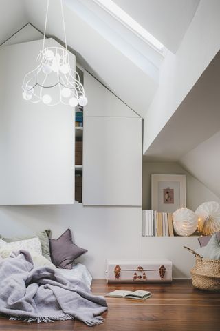 Playroom storage ideas with built-in cupboards in a loft roof