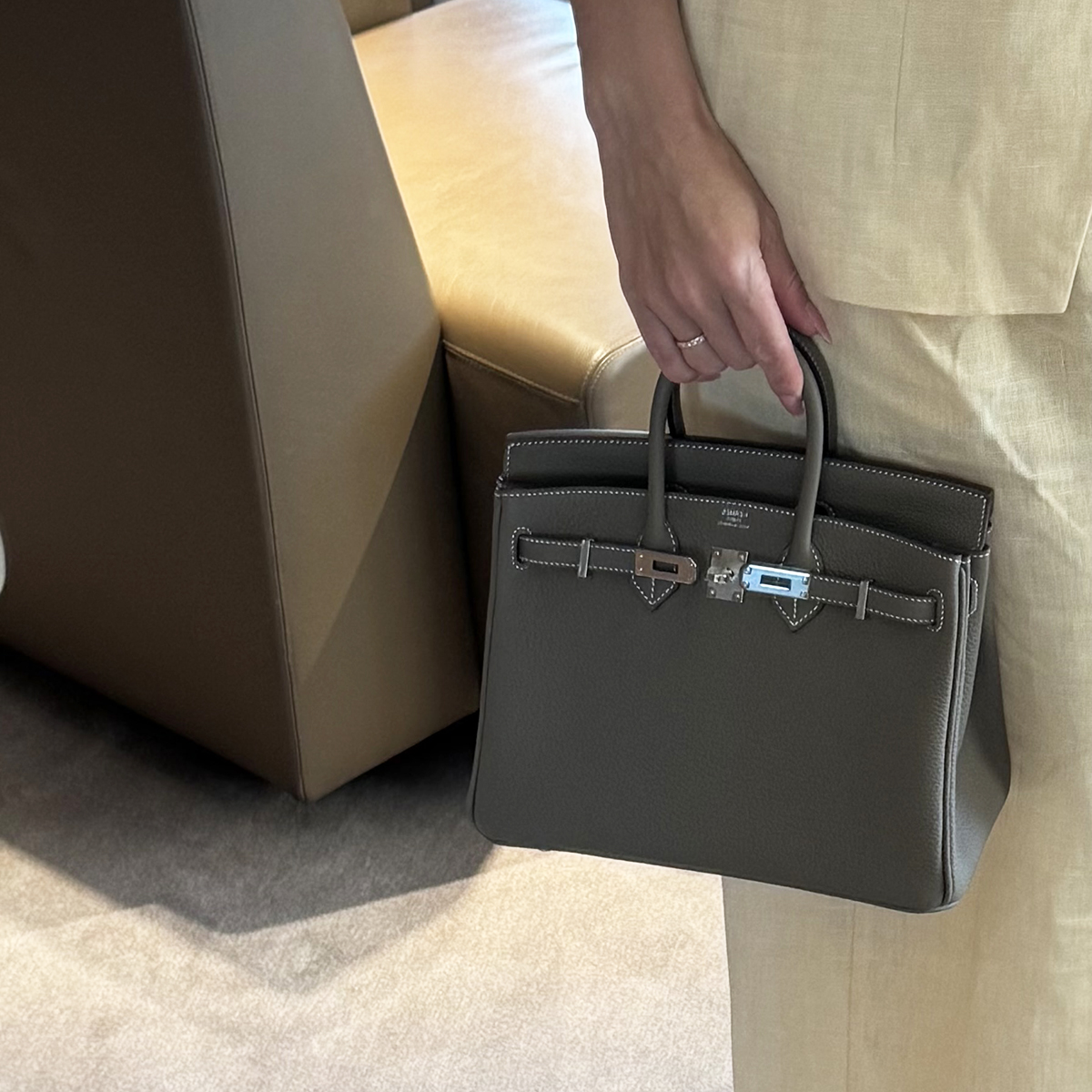 Bettina Looney holding a gray Hermès Kelly bag