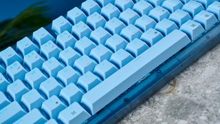 A glacier blue Corsair K65 Plus wireless mechanical keyboard for Mac