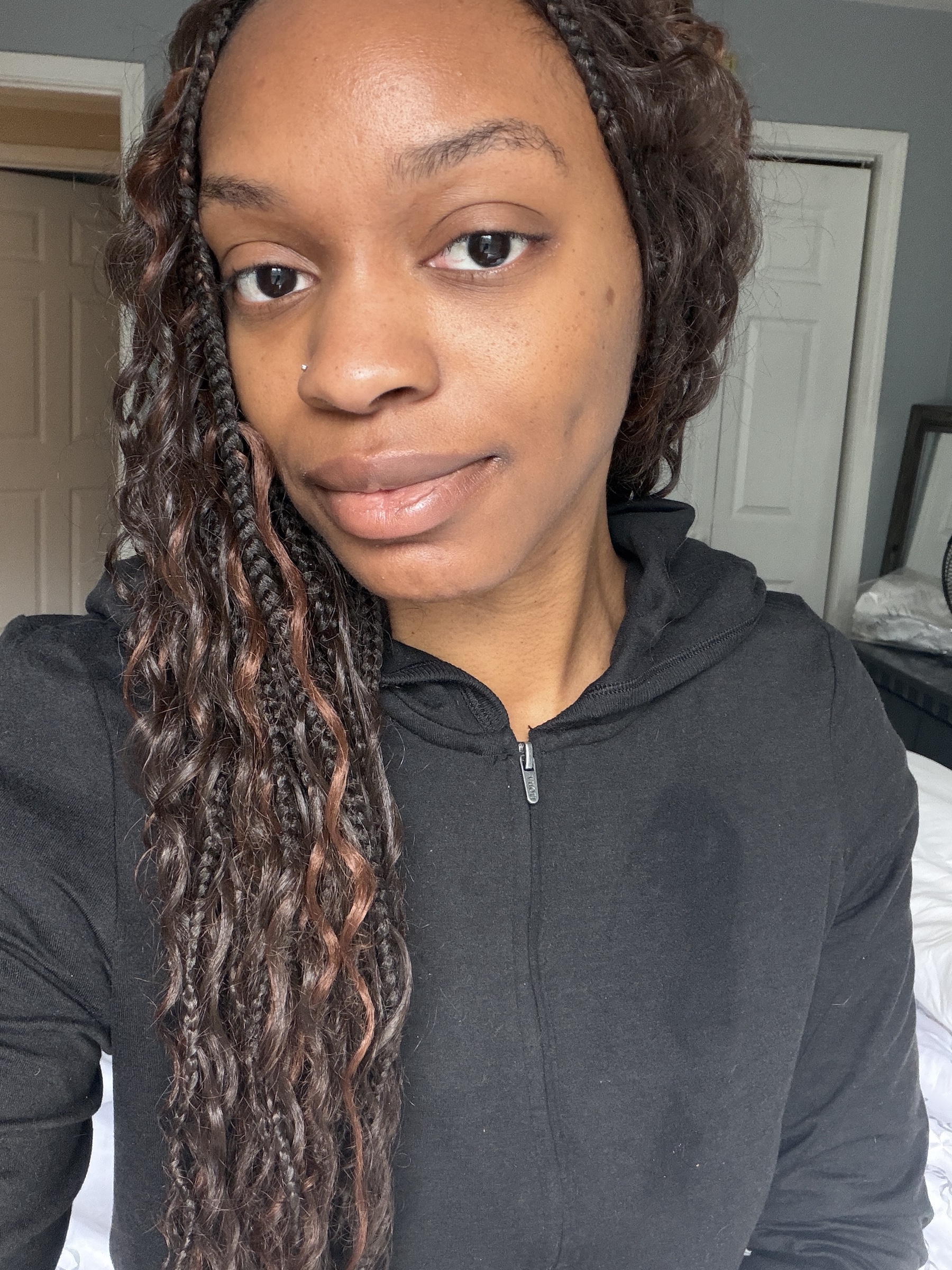 a before photo of a woman testing a black liquid eyeliner