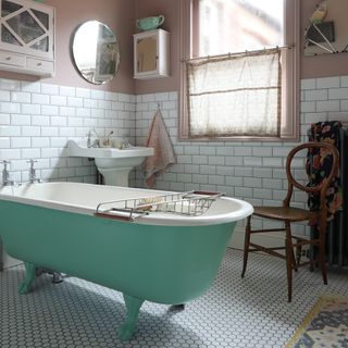 vintage style bathroom with salvaged bath and sinks and white metro tiles