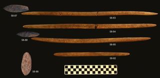 Researchers found stone darts or spears, and foreshafts made out of carved antlers in the prehistoric grave.