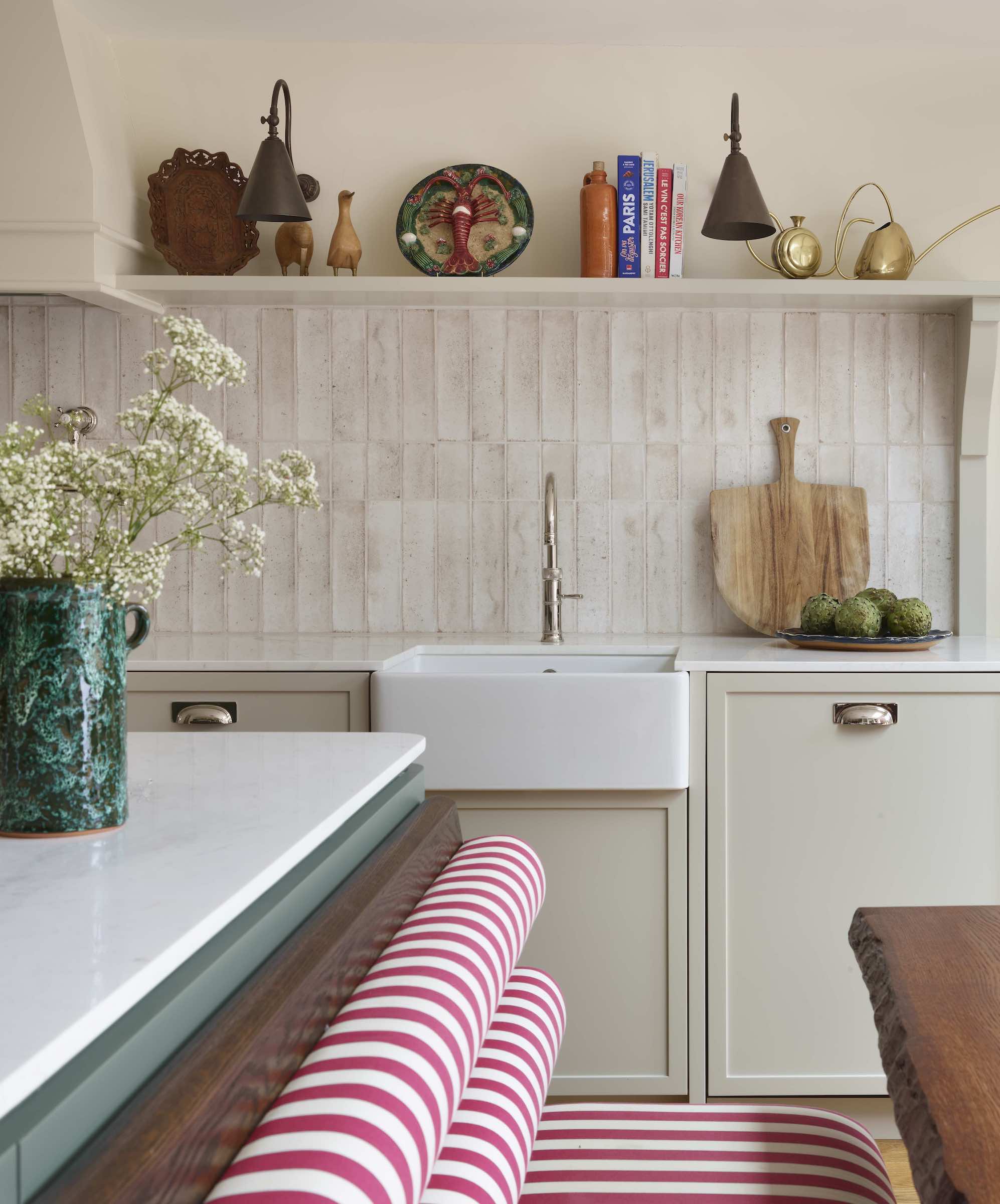 off white kitchen with striped banquette and belfast sink