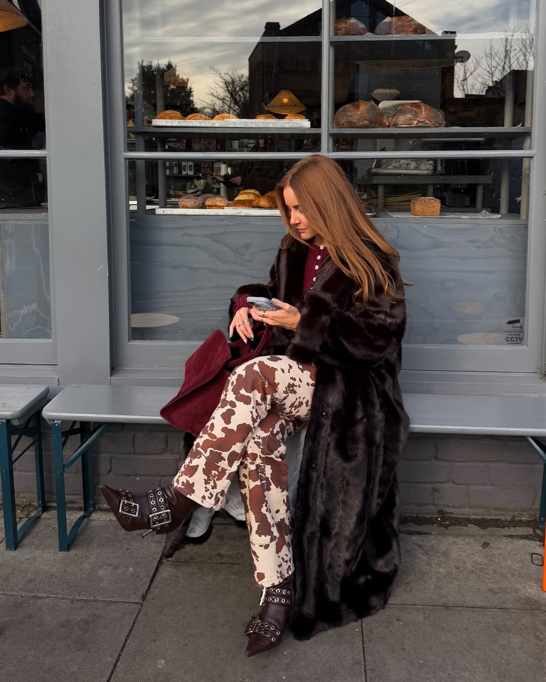 @rebeccaferrazwyatt wears cow print trousers, buckled boots and faux fur coat