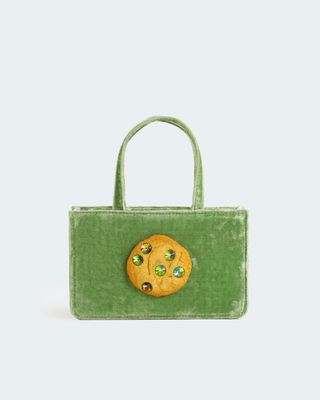 green velvet bag with a cookie on the front