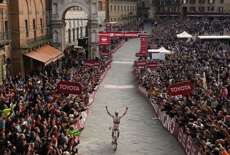 Tadej Pogačar arrives at the Piazza del Campo to take victory at Strade Bianche