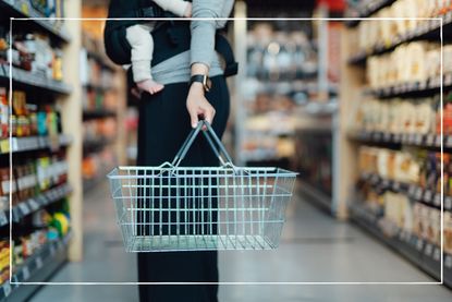 mother shopping whilst holding baby