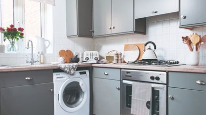 A grey kitchen with a patterned floor