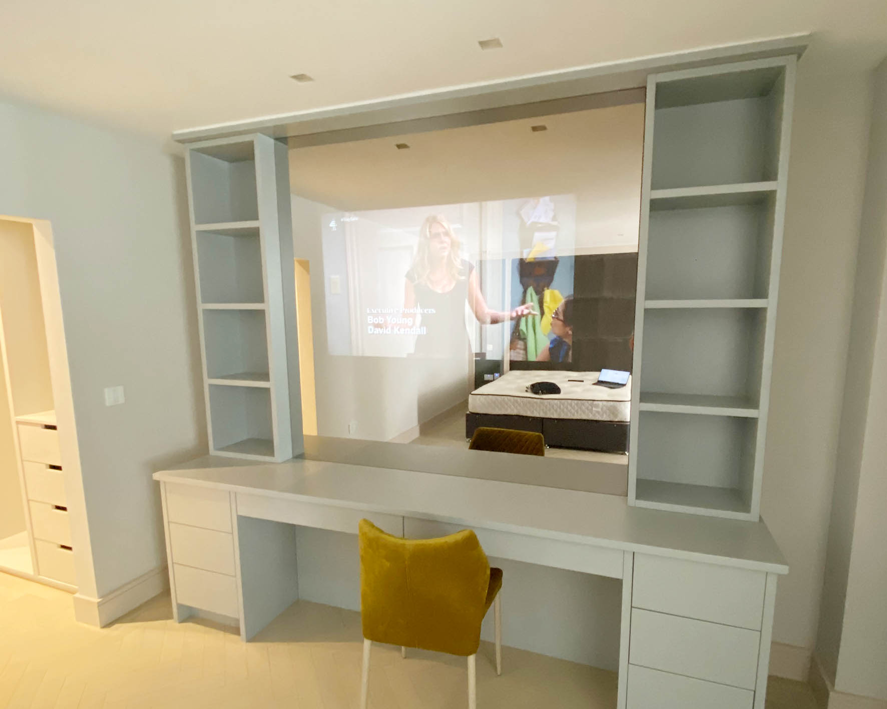 TV integrated behind a mirror in a dressing table