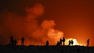 People view the volcano on the Reykjanes peninsula in south west Iceland which has erupted after weeks of intense earthquake activity/ on December 19, 2023 in Grindavik, Iceland.