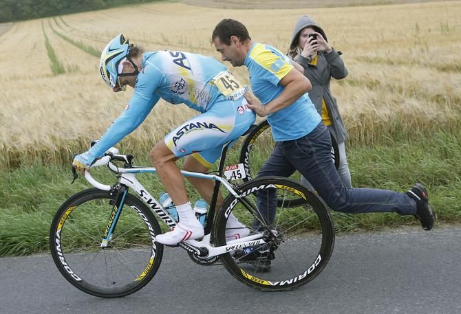 Maxim Iglinskiy (Astana) gets a push after an incident