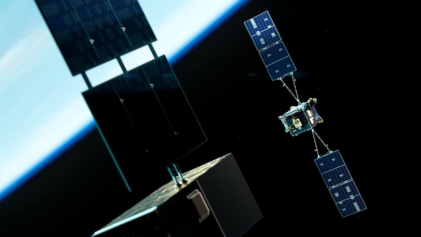An illustration of two satellites with opposing solar panels on either side floating above the glowing blue atmosphere of Earth 