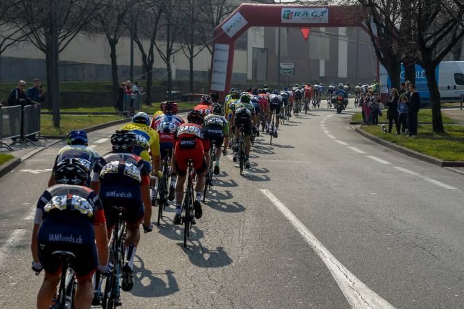 The peloton lined out as it passes under the flamme rouge in stage 5 at Paris-Nice