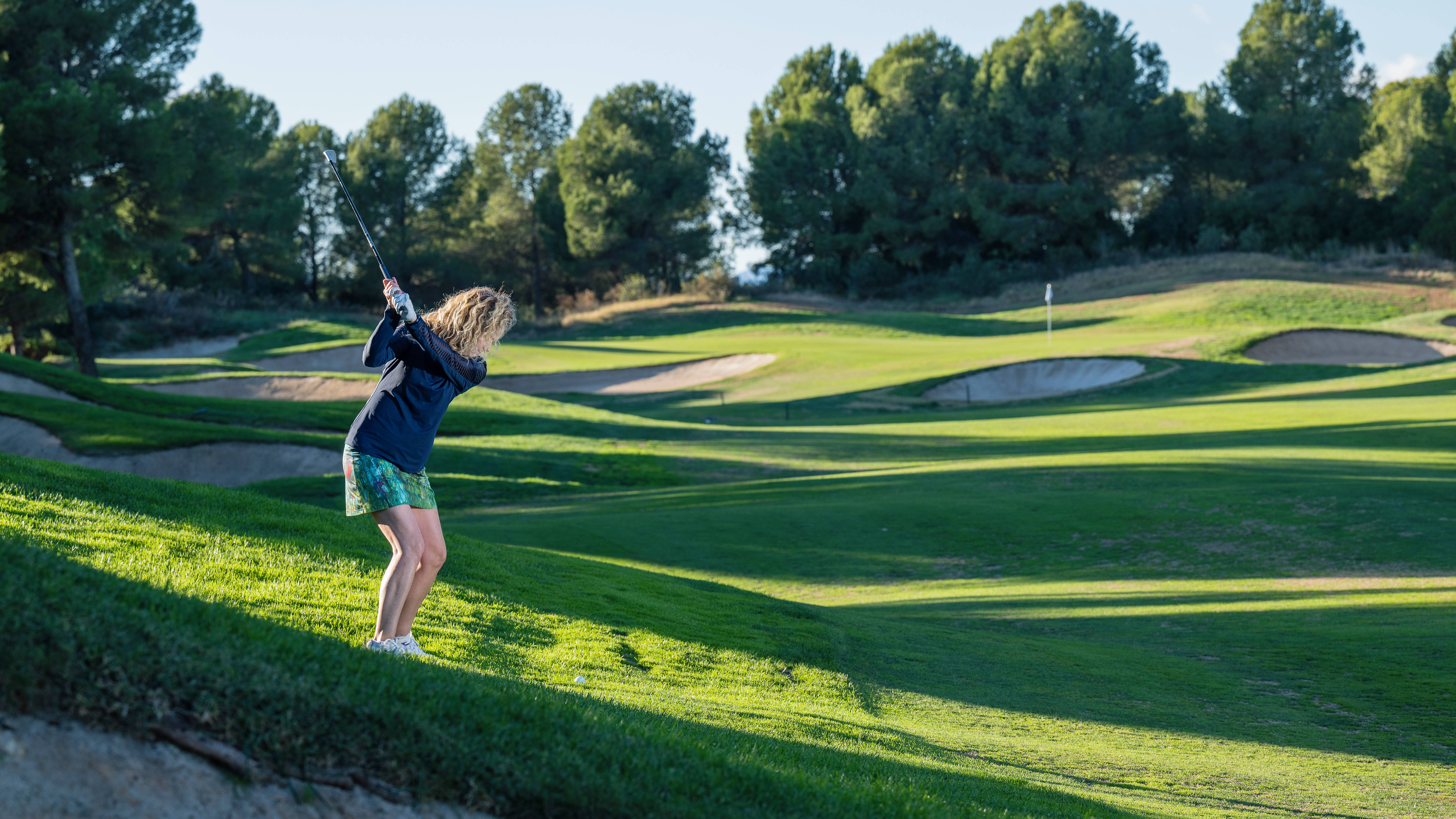 Katie Dawkins hitting an approach shot to a green