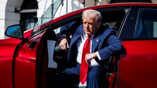 President Trump getting out of a red electric car
