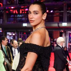 Dua Lipa joins Callum Turner at the Rosebush Pruning premiere during the 76th Berlinale International Film Festival Berlin wearing a Chanel naked dress and Bulgari jewels on February 14, 2026