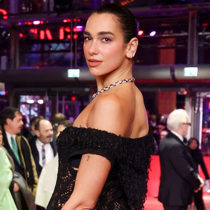 Dua Lipa joins Callum Turner at the Rosebush Pruning premiere during the 76th Berlinale International Film Festival Berlin wearing a Chanel naked dress and Bulgari jewels on February 14, 2026