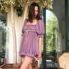 Alexa Chung wears gold heels.