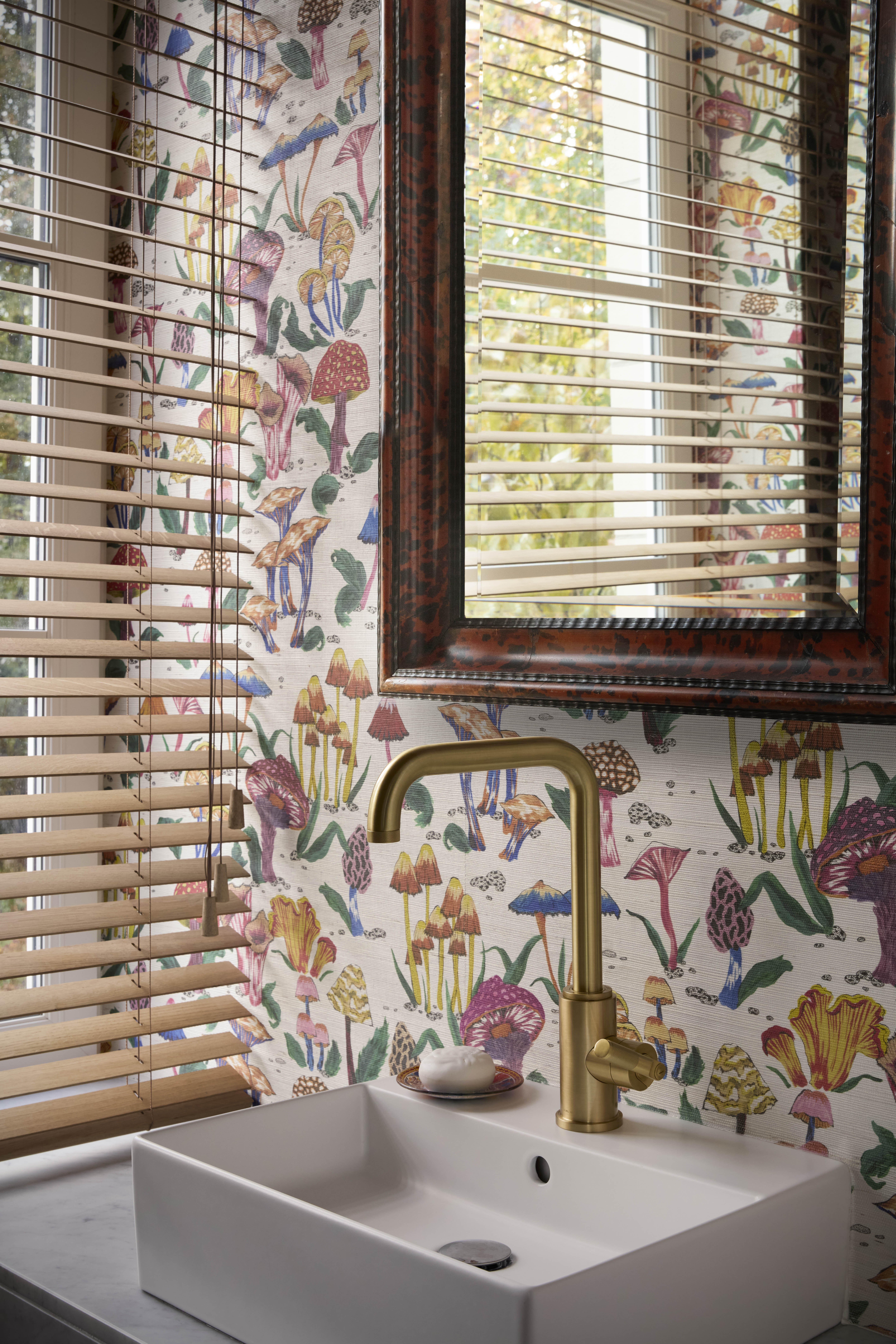 A bathroom with wall covered in mosaic tiles