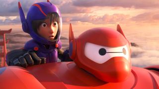 A young boy on Baymax during one of the best Disney movies, Big Hero Six.