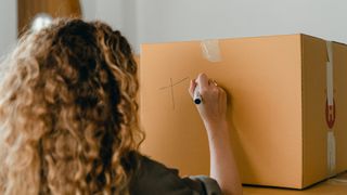 Woman labelling a box