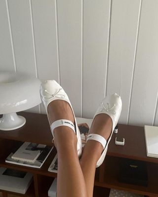 Influencer wears white mary janes.