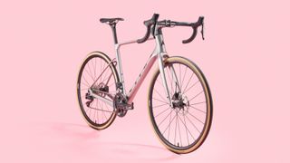 Vitus Venon Evo 105 Di2 carbon road bike on a pink background