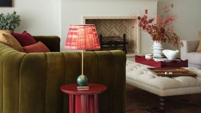 a wireless table lamp in a living rom with a green sofa