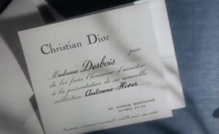 View of a white card with the wording 'Christian Dior' at the top and text in French below