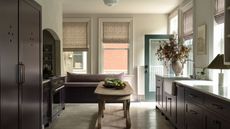 A white and burgundy kitchen with cabinet cutout details