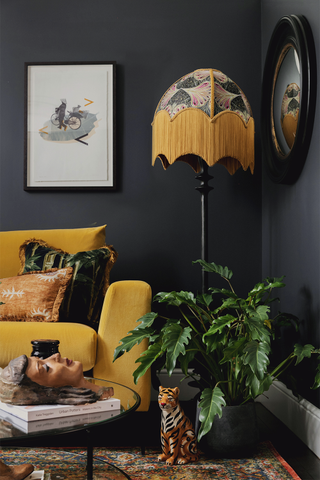a black painted living room with bright yellow furniture