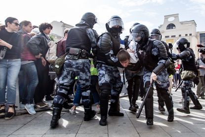 RUSSIA, MOSCOW - 2019/08/03: Police officers detain a man during an unsanctioned rally in the centre of Moscow, Russia.Moscow police detained more than 300 people who were protesting against 