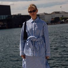 woman wearing striped shirt and skirt 