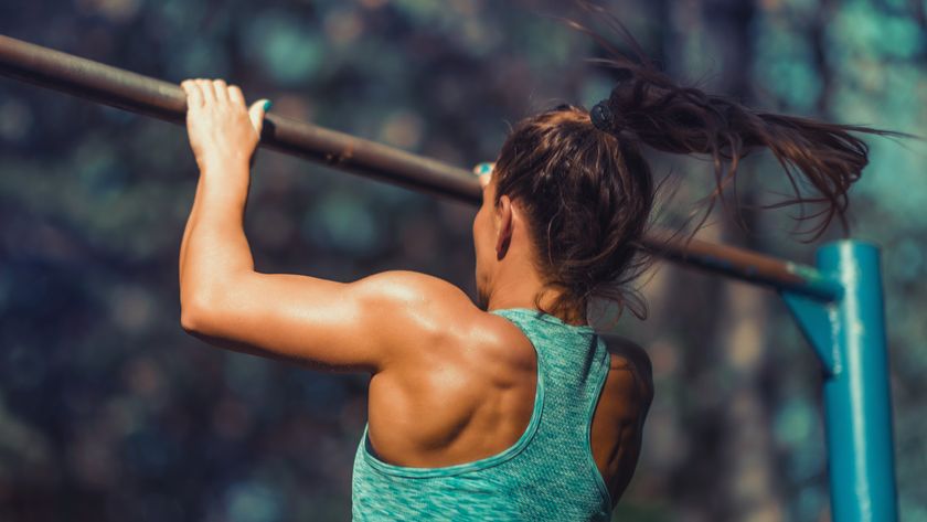 a woman doing a pull up