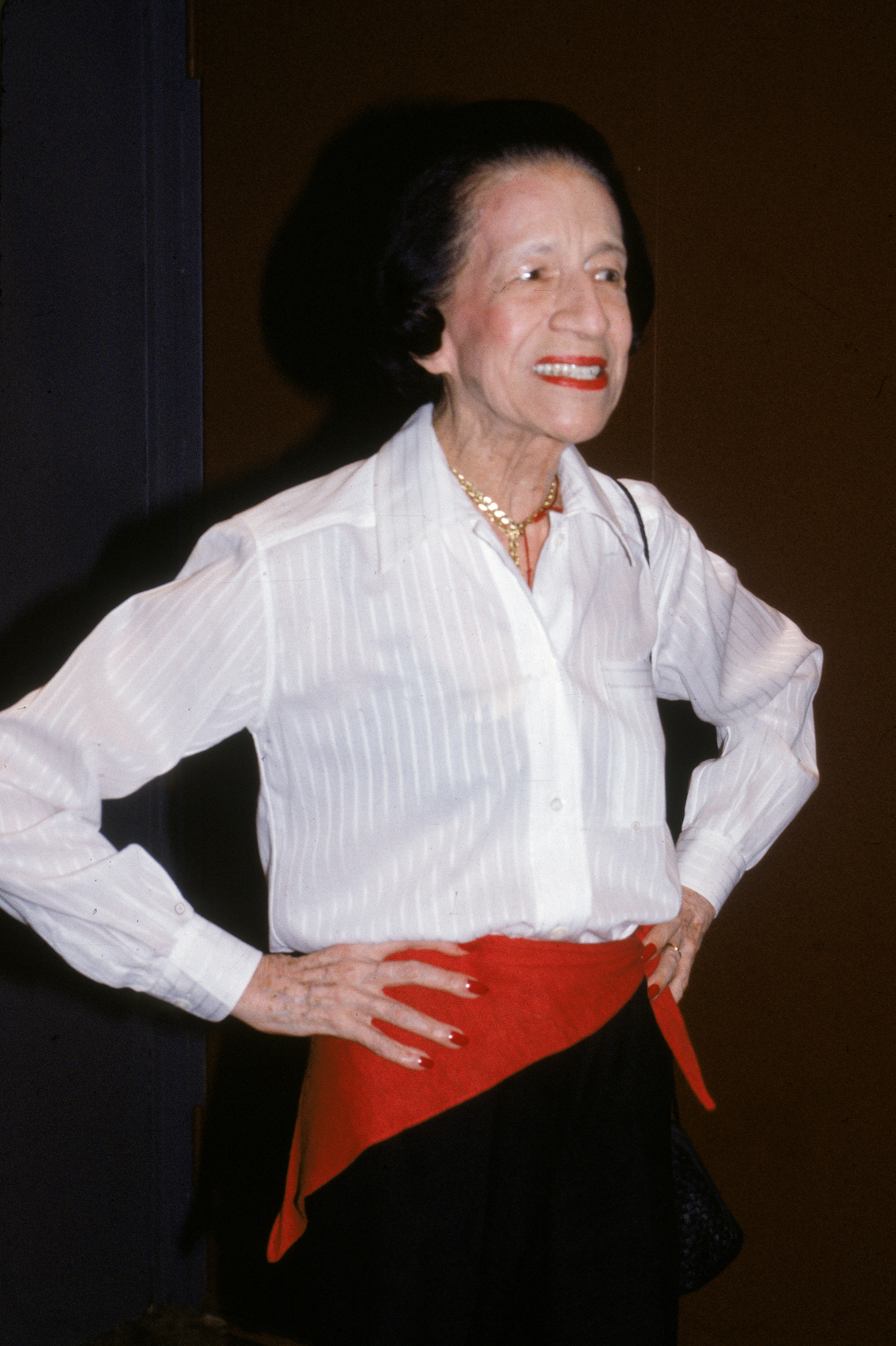 American fashion writer and editor Diana Vreeland with a red scarf worn as a belt on July 6, 1983.