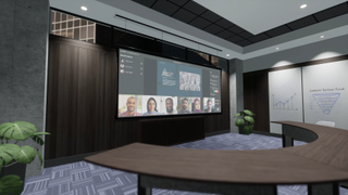 A videoconference in progress on a massive screen with a presentation and six faces. 