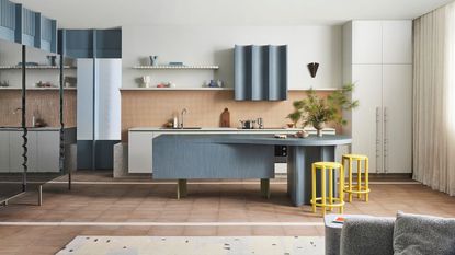 modern kitchen with blue and terracotta and curved island 