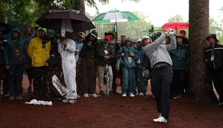 Cameron Young strikes a shot from the pine straw at Augusta National