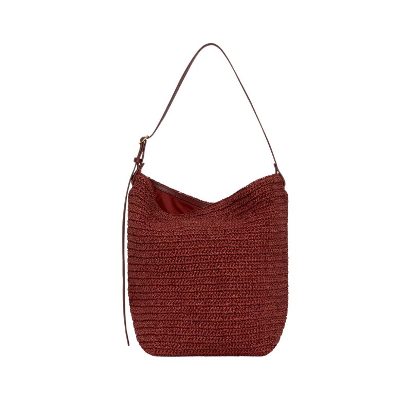 A cutout of a burgundy straw bag by Arket