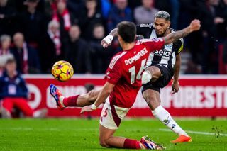 Joelinton of Newcastle United FC shoots to score his team's second goal during the Premier League match between Nottingham Forest FC and Newcastle United FC at City Ground on November 10, 2024 in Nottingham, England