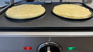 adding pancake batter to pancake maker