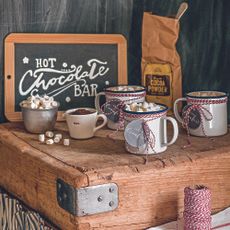 room with slate board with wooden frame and coffee mugs on wooden table 