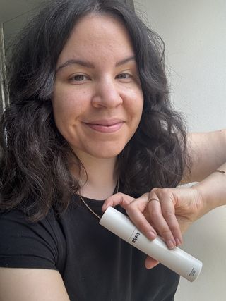 mica holding a tube of Refy Skin Trio SPF 50