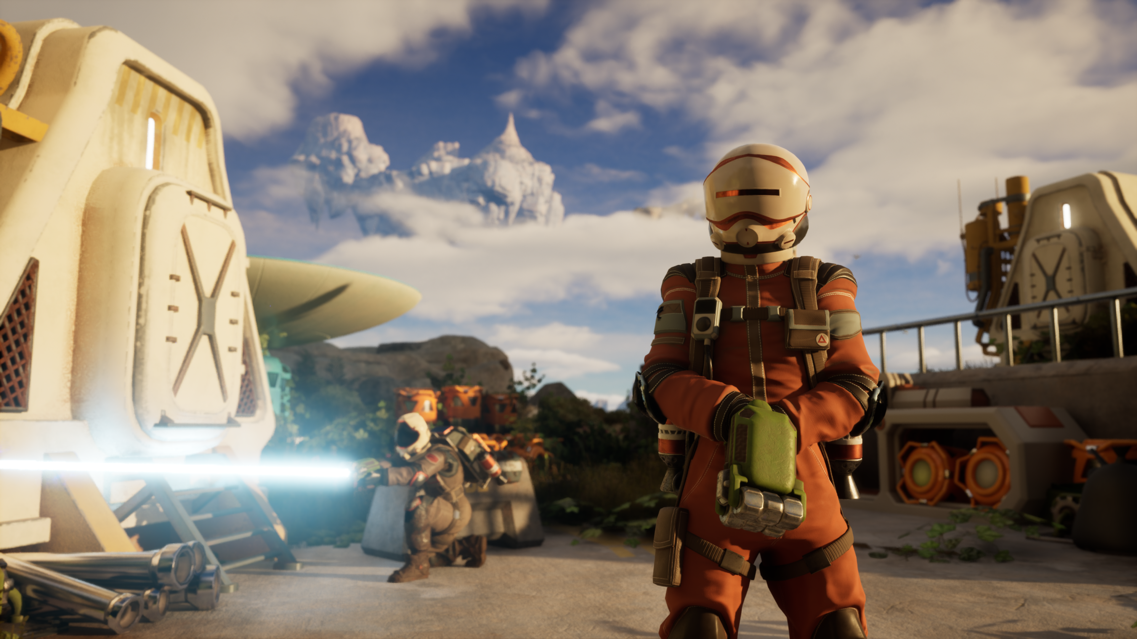 A vagabond stands in the foreground as another spacesuit-wearing character shoots a white beam from a crouched position 