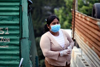 A woman in Guatemala wears a face mask.