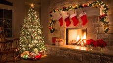 A Christmas tree with garland hanging on a mantel